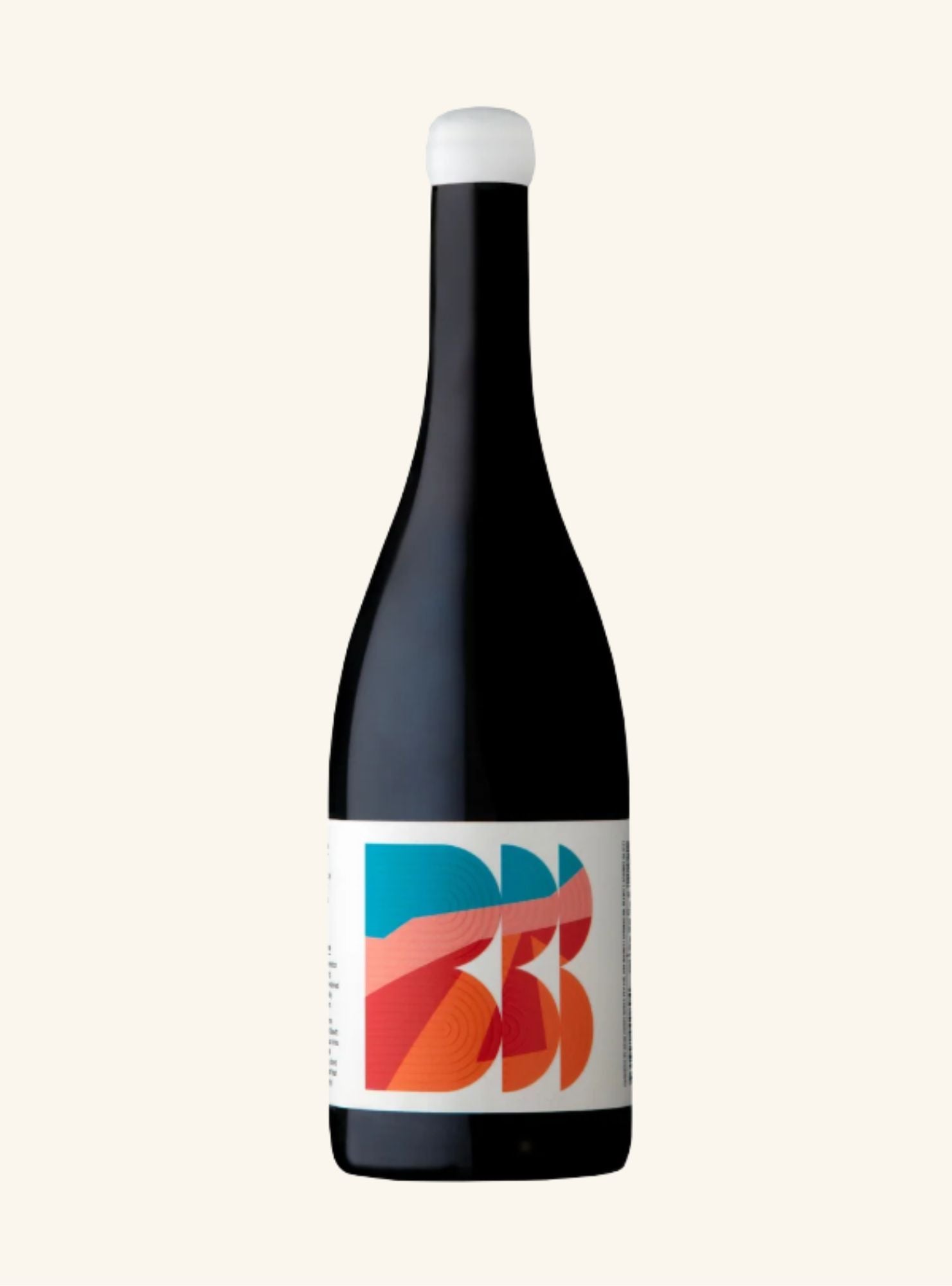 A dark glass bottle with a white label featuring a colorful abstract graphic, set against a solid off-white background.