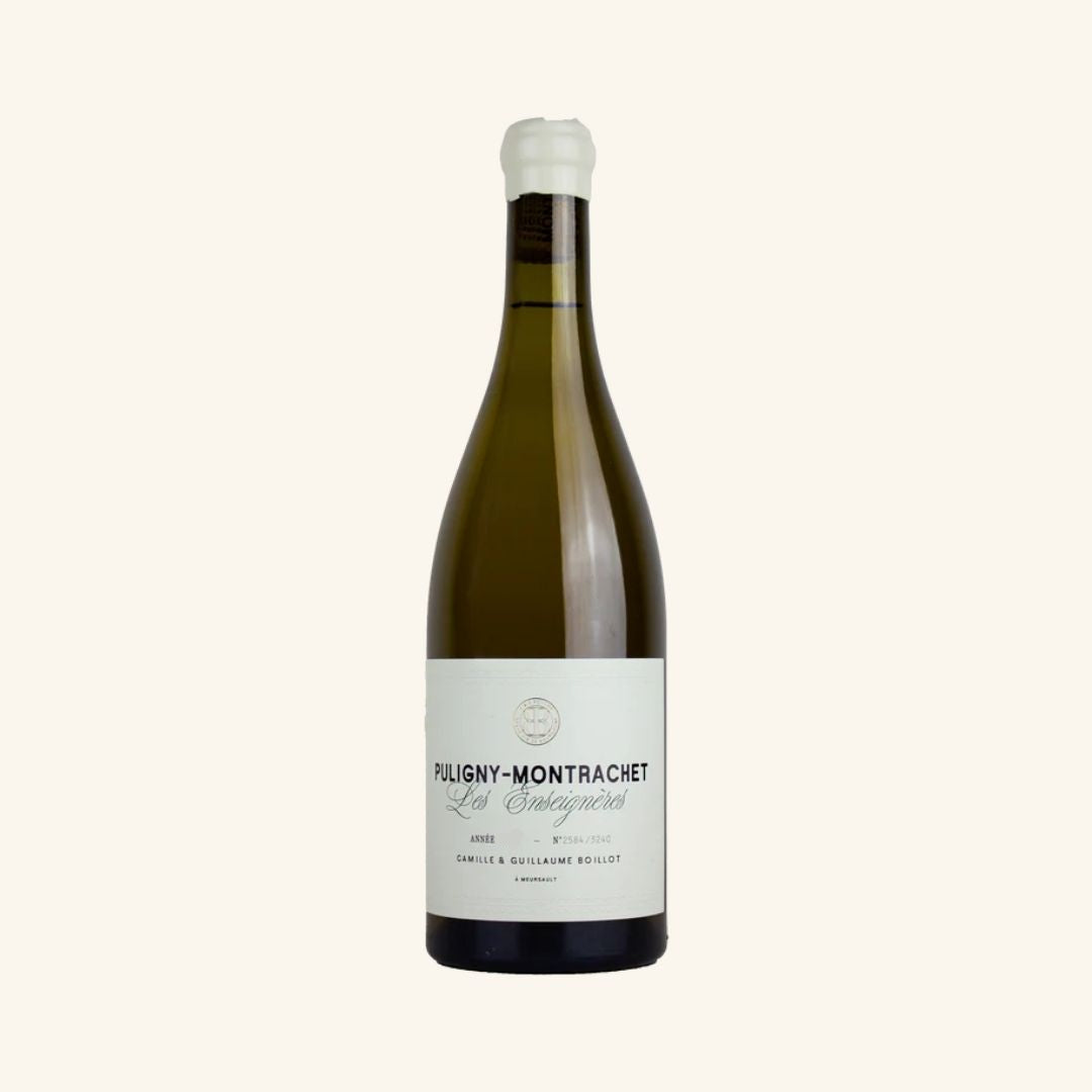 Wine bottle labeled 'Puligny-Montrachet' les enseigneres on a white background
