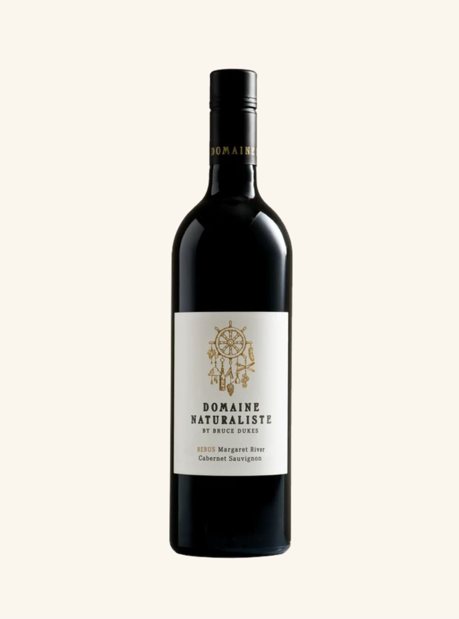 A dark coloured wine bottle with a white label, black writing and a gold logo, set on an off white background. 