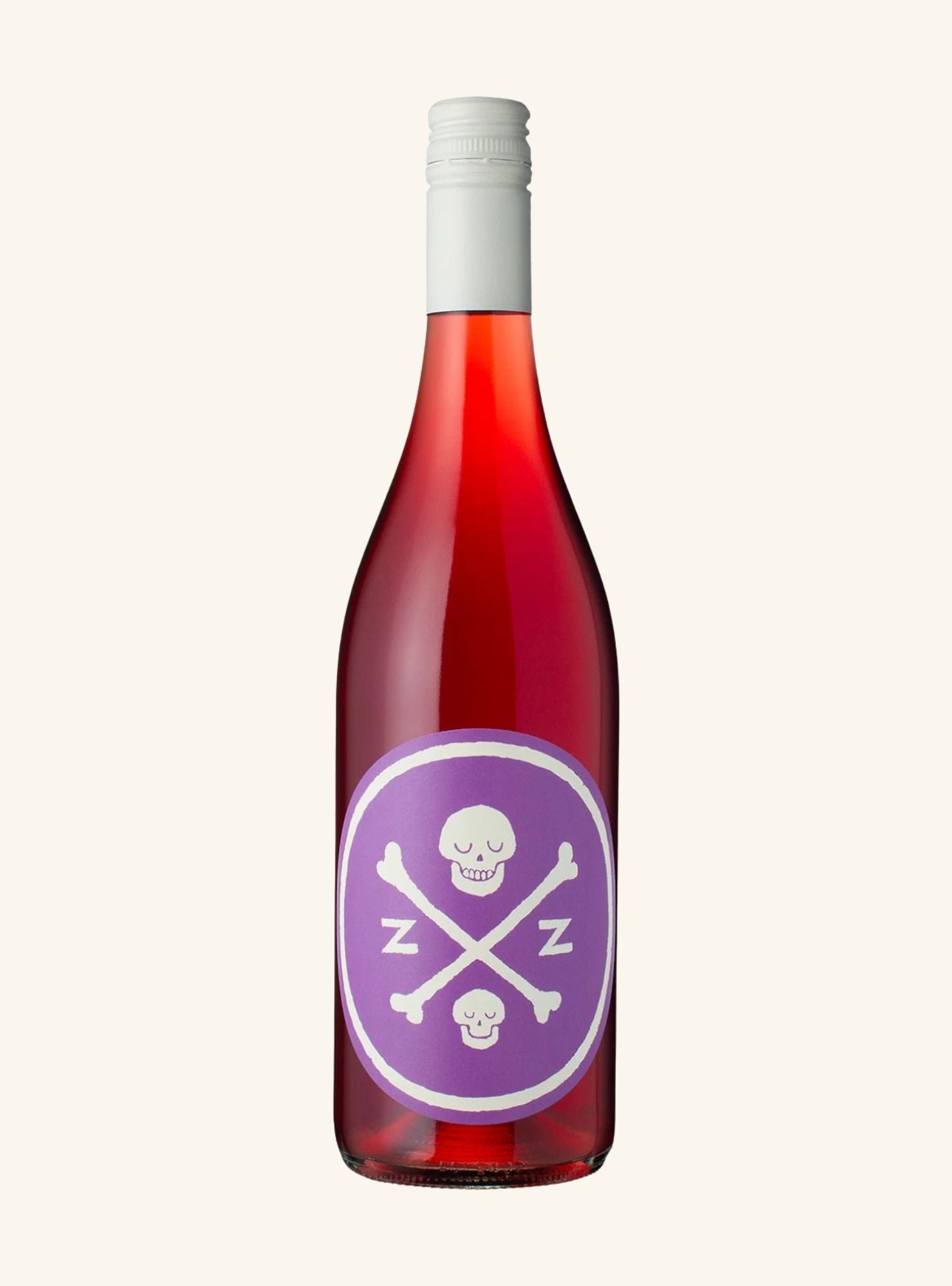 A bottle of rosé wine with a purple circular label featuring a white skull and crossbones design with the letters 'Z' and 'Z'. The wine inside is a deep red-pink color, and the bottle is sealed with a white cap, set against a solid off-white background.