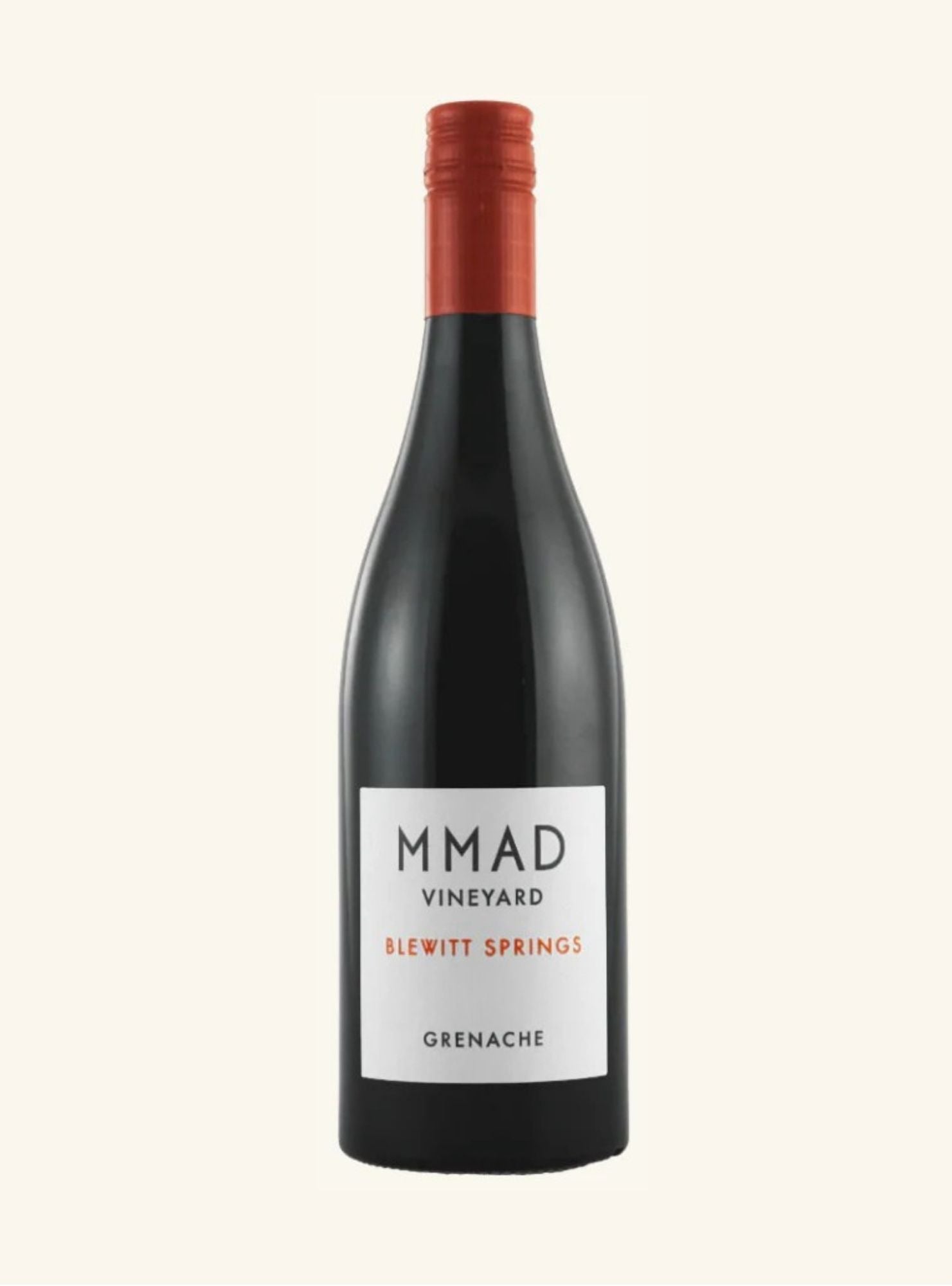 bottle of wine with red cap and white label with MMAD vineyard Blewitt  Springs Grenache written on it, on a light gray background