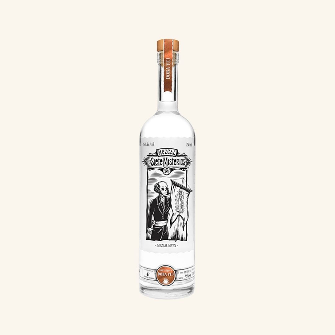 Bottle of los siete misterios doba yej mezcal on a white background