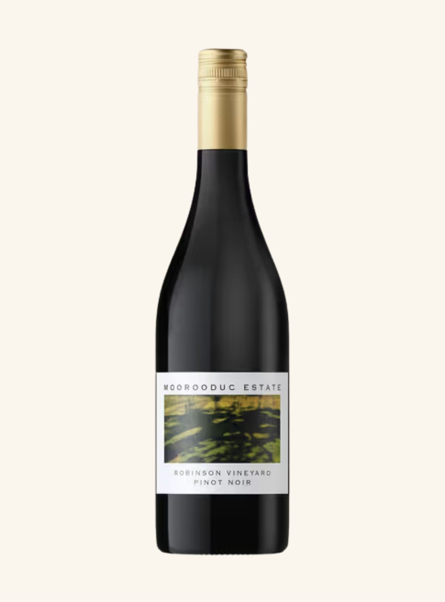 A dark colored wine bottle with a gold lid and a white label set on an off-white background. 