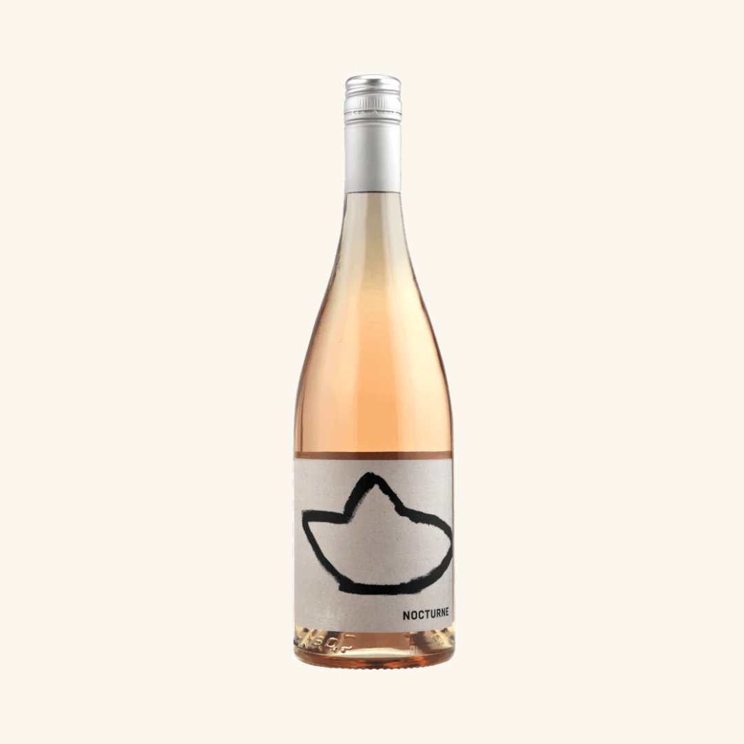 A bottle of Nocturne SR Rose wine with a pink hue and a label that includes a brand artwork and the brand name.