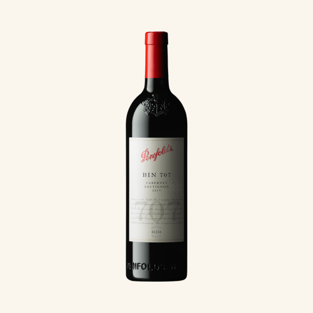 A bottle of Penfolds Bin 707 Cabernet Sauvignon red wine with a white label, red capsule and red text.