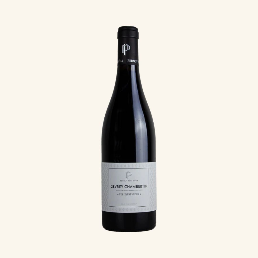 Wine bottle with a label branded pernot pere+fils gevrey-chambertin les jeunes rois on a white background