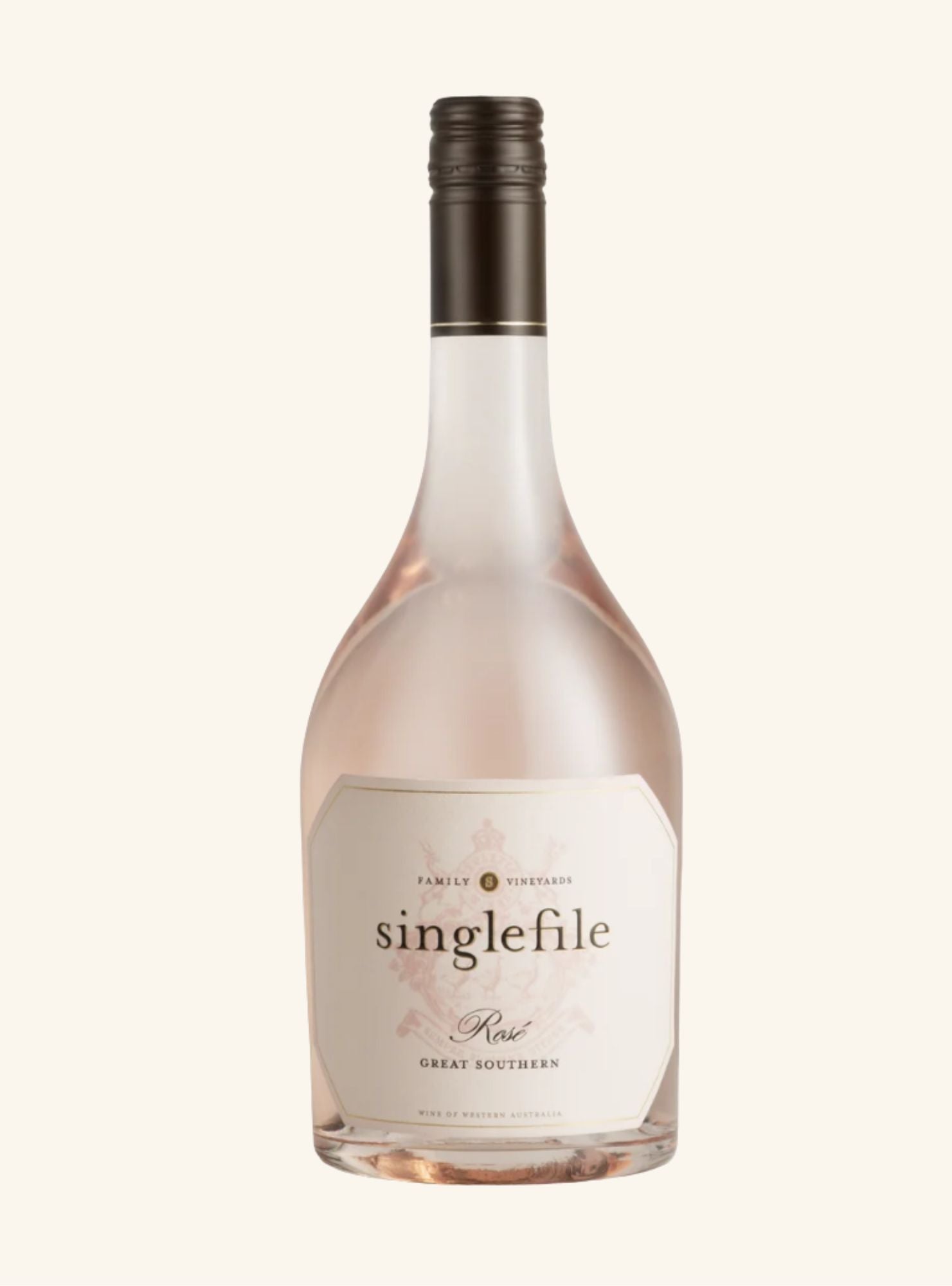 Light pink colored bottle with a brown lid and a light pink label set on an off-white background. 