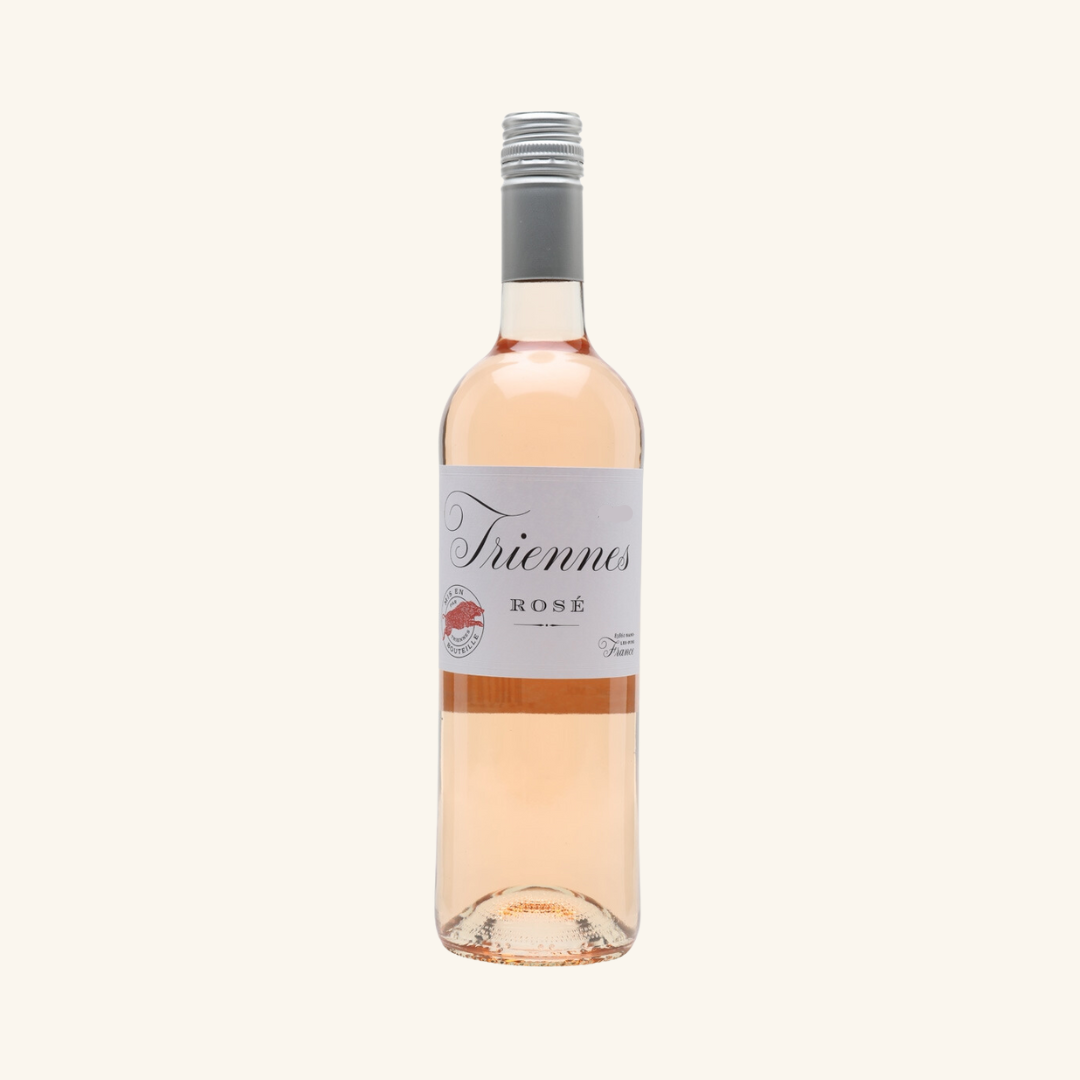 A bottle of Triennes Rosé wine with a pink hue and a label that includes the brand name and the variety of wine.