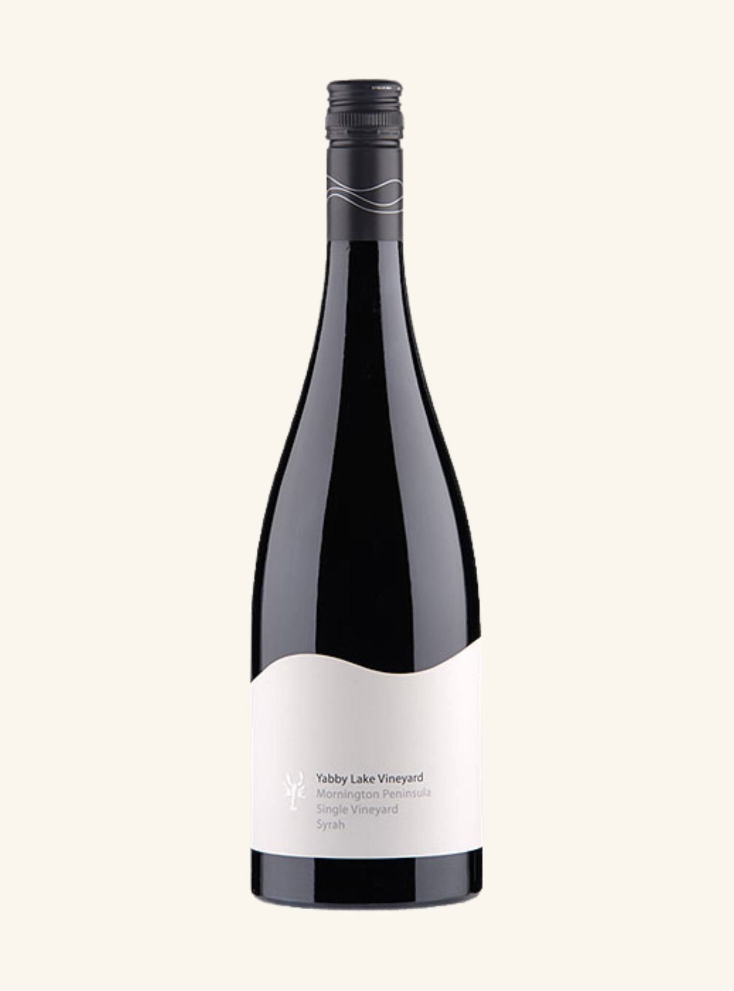 A dark colored wine bottle with a black screw cap and white label on an off white background. 