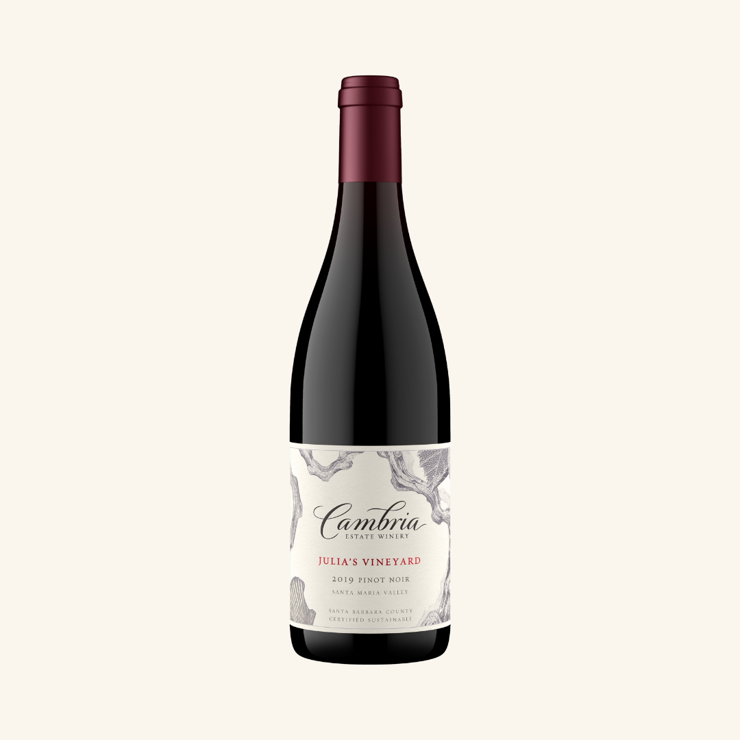A bottle of Cambria Julia's Vineyard Pinot Noir wine with a label showing the brand, vineyard name, and additional details.