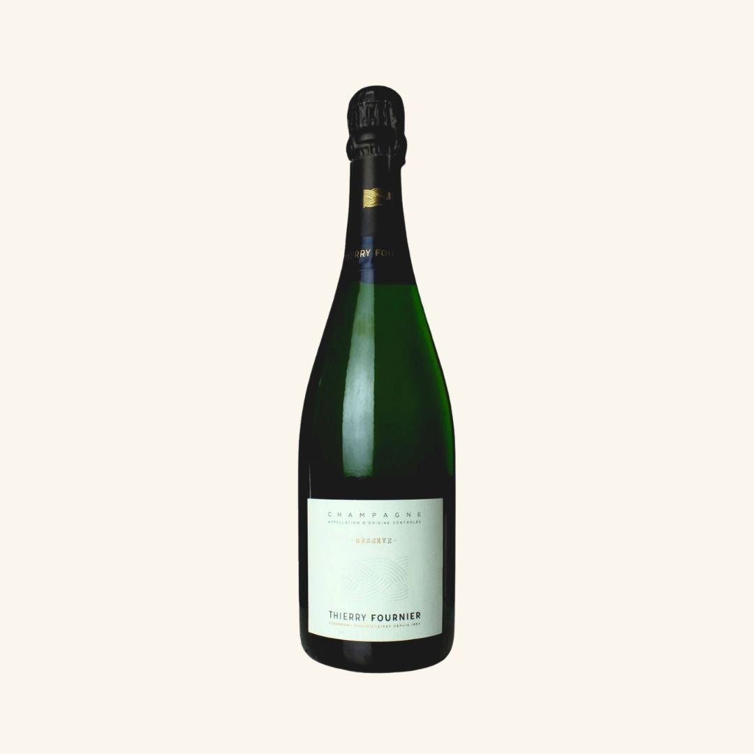 Green wine bottle with a white label branded Champagne Reserve Thierry Fournier on a white background