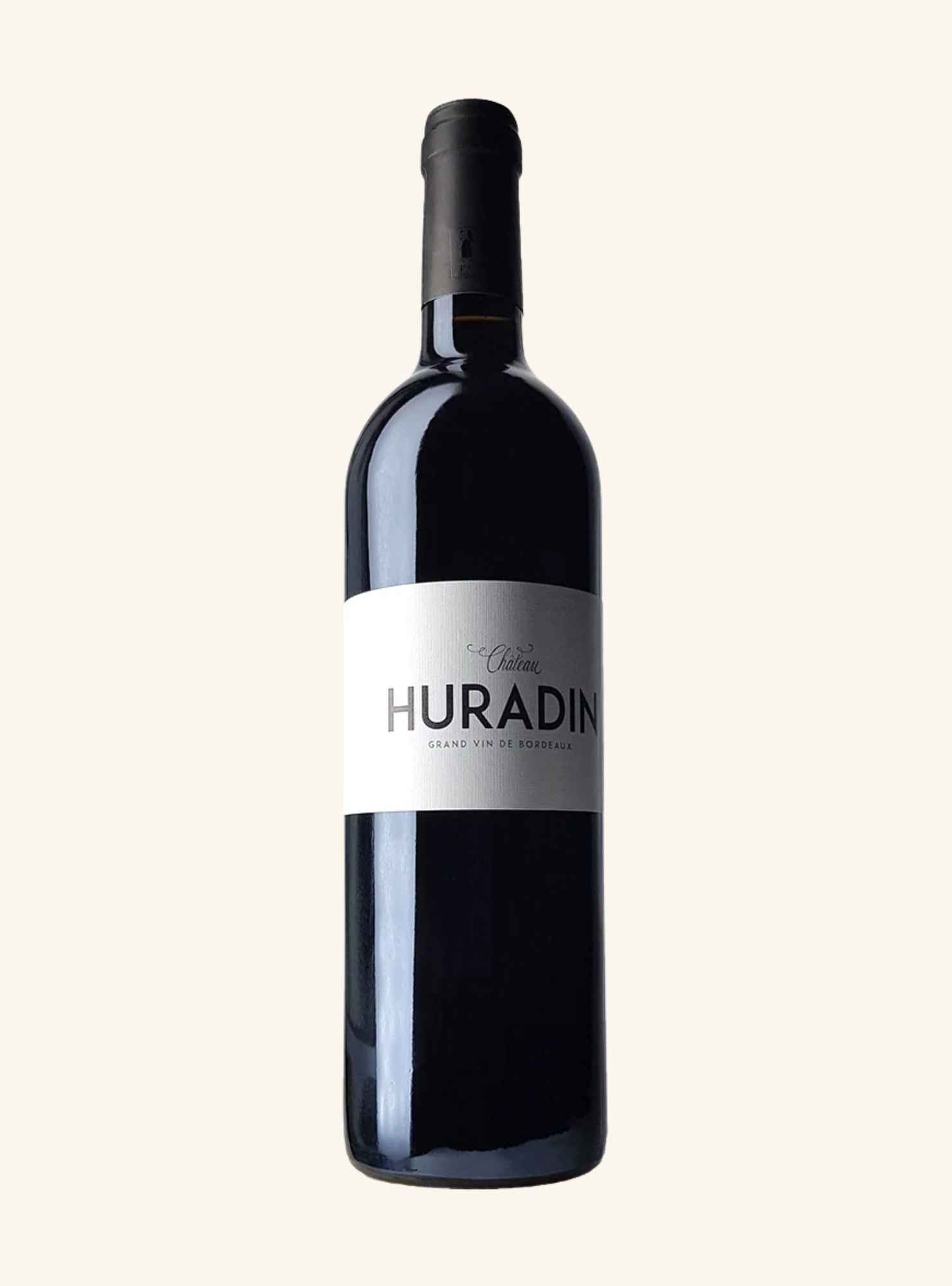 bottle of red wine in a black bottle with a white label branded chateau huradin, all superimposed on a white background.