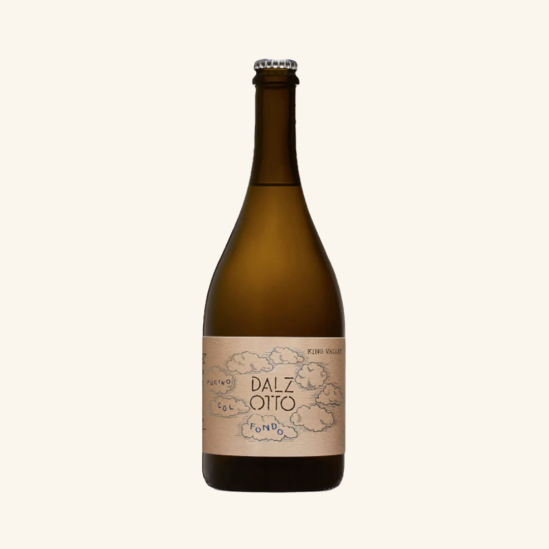 A bottle of Dal Zotto Pucino Col Fondo Prosecco with a beige label, predominantly beige background.