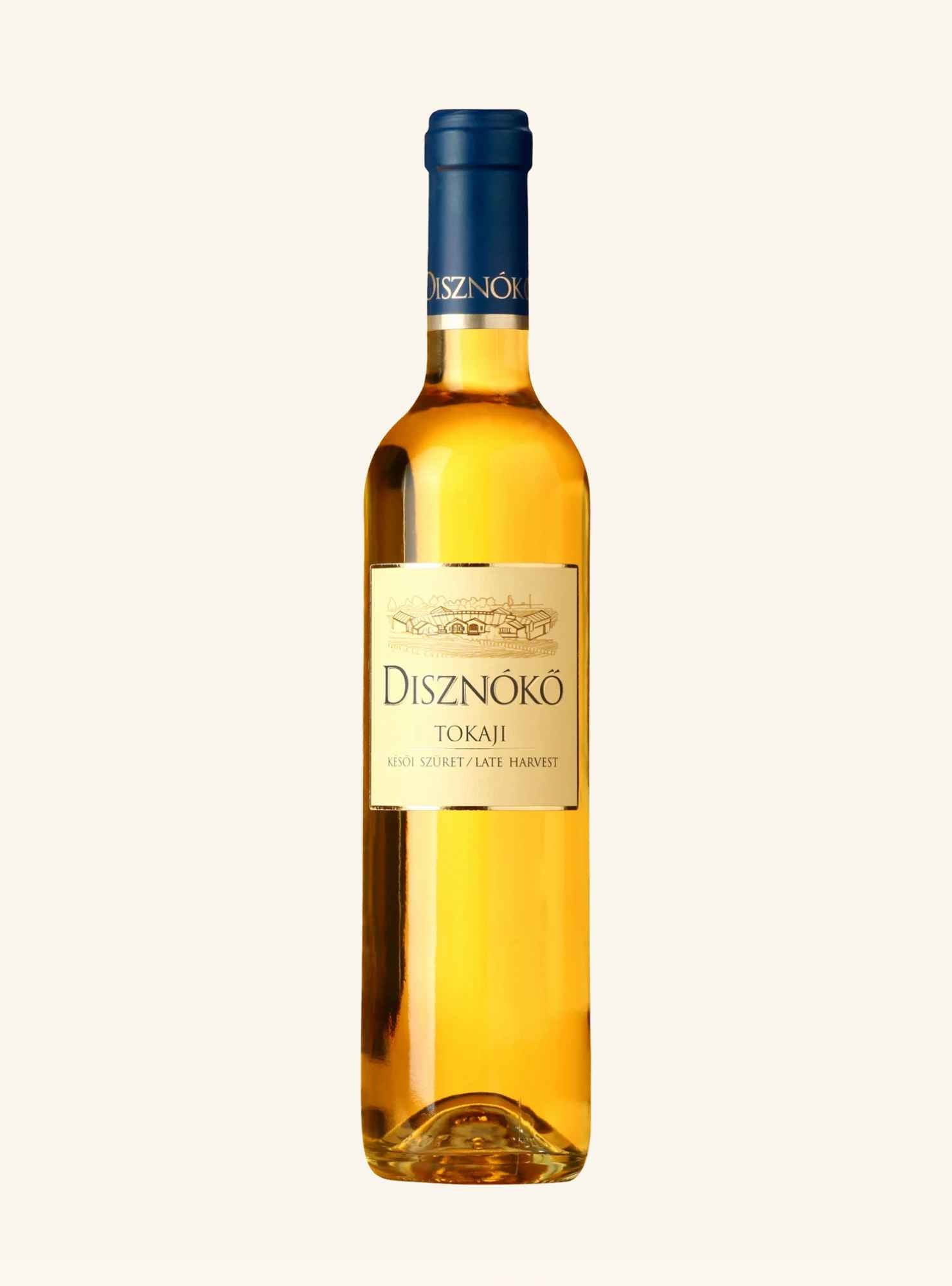 A bottle of Disznoko Tokaji white dessert wine with a gold label and a dark blue foil capsule, set against a solid off-white background.