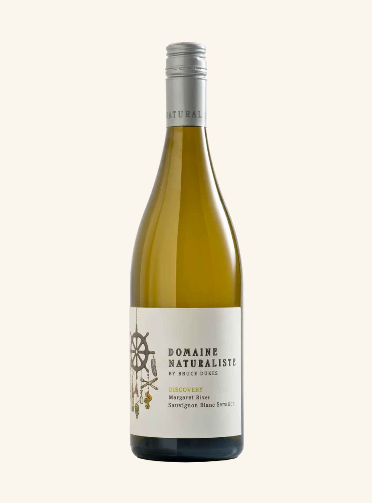 A bottle of domaine naturaliste discovery sauvignon blanc semillon, white wine with a pale gold-amber glass body, a white label with black text and a small illustration, and a silver capsule cap, centered on a light cream background.
