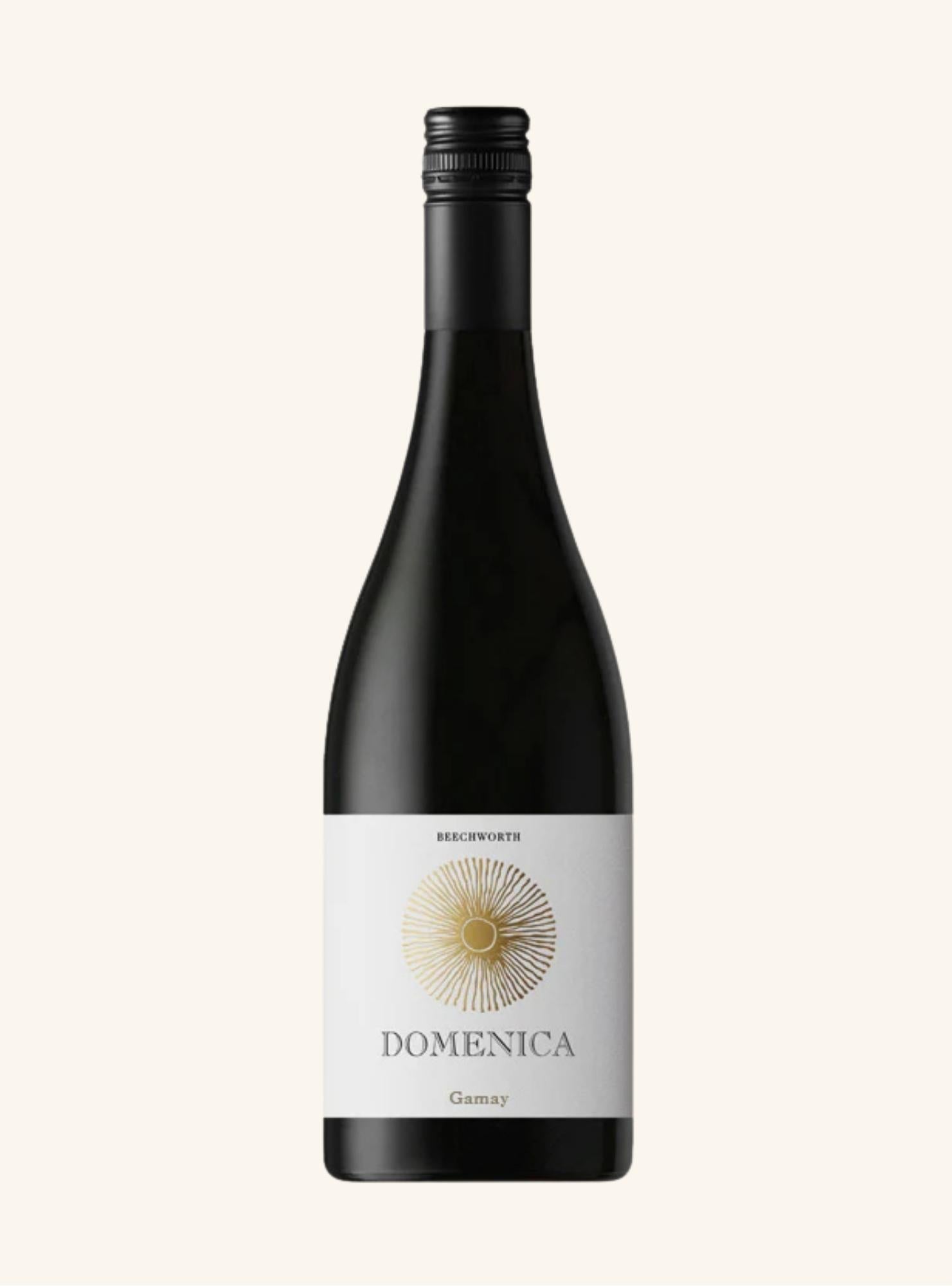Wine bottle with 'Domenica Gamay' label on a white background
