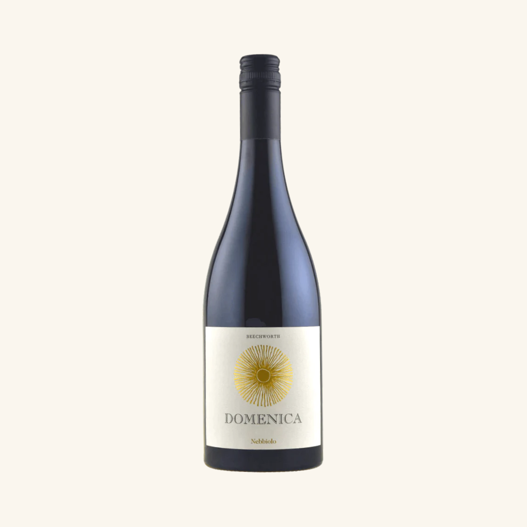 Bottle of Domenica Nebbiolo wine with a white label featuring a yellow sun illustration, against a plain background.