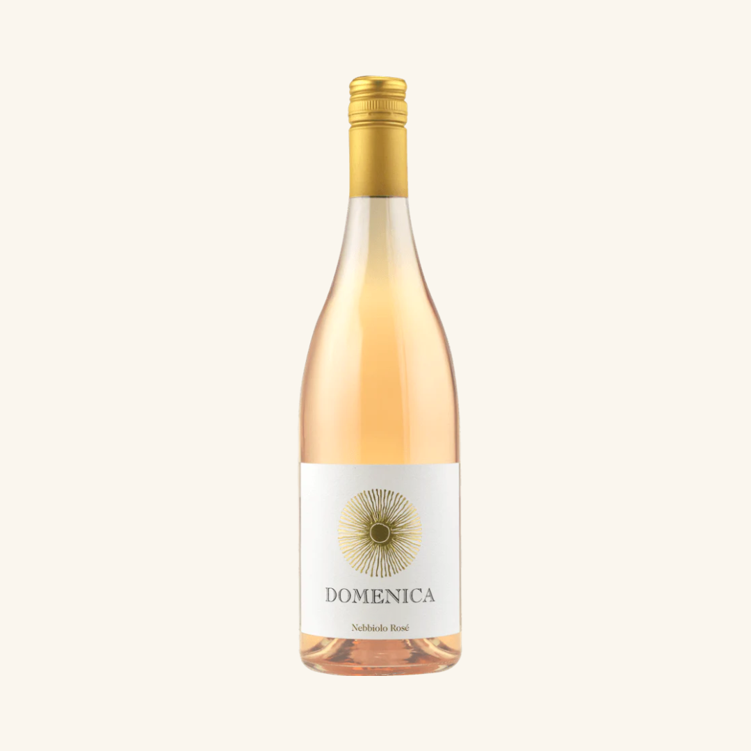 A bottle of Domenica Nebbiolo Rosé wine with a clear label displaying the brand and variety.