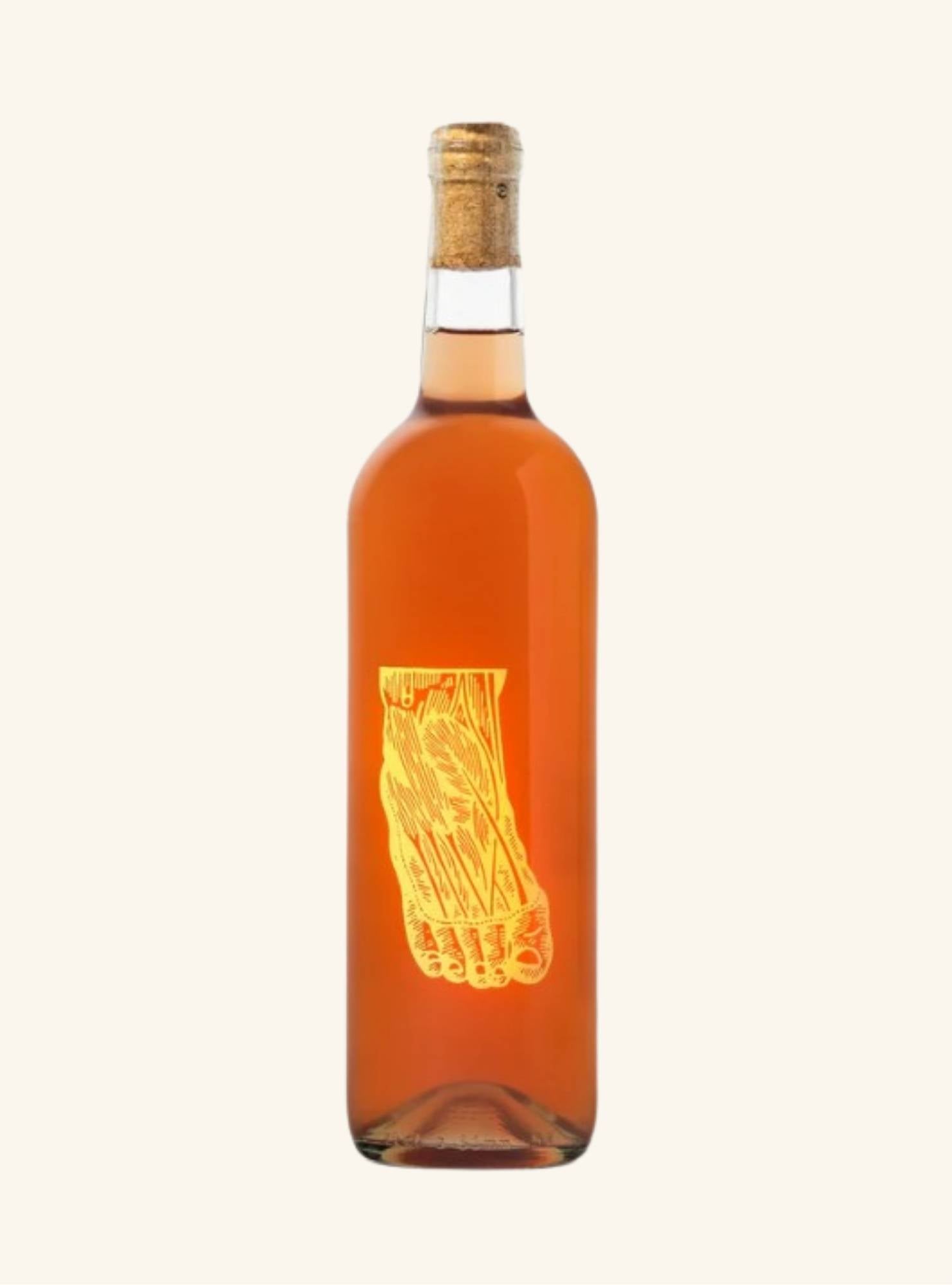 Bottle of amber liquid with cork cap and a picture of a foot on a white background