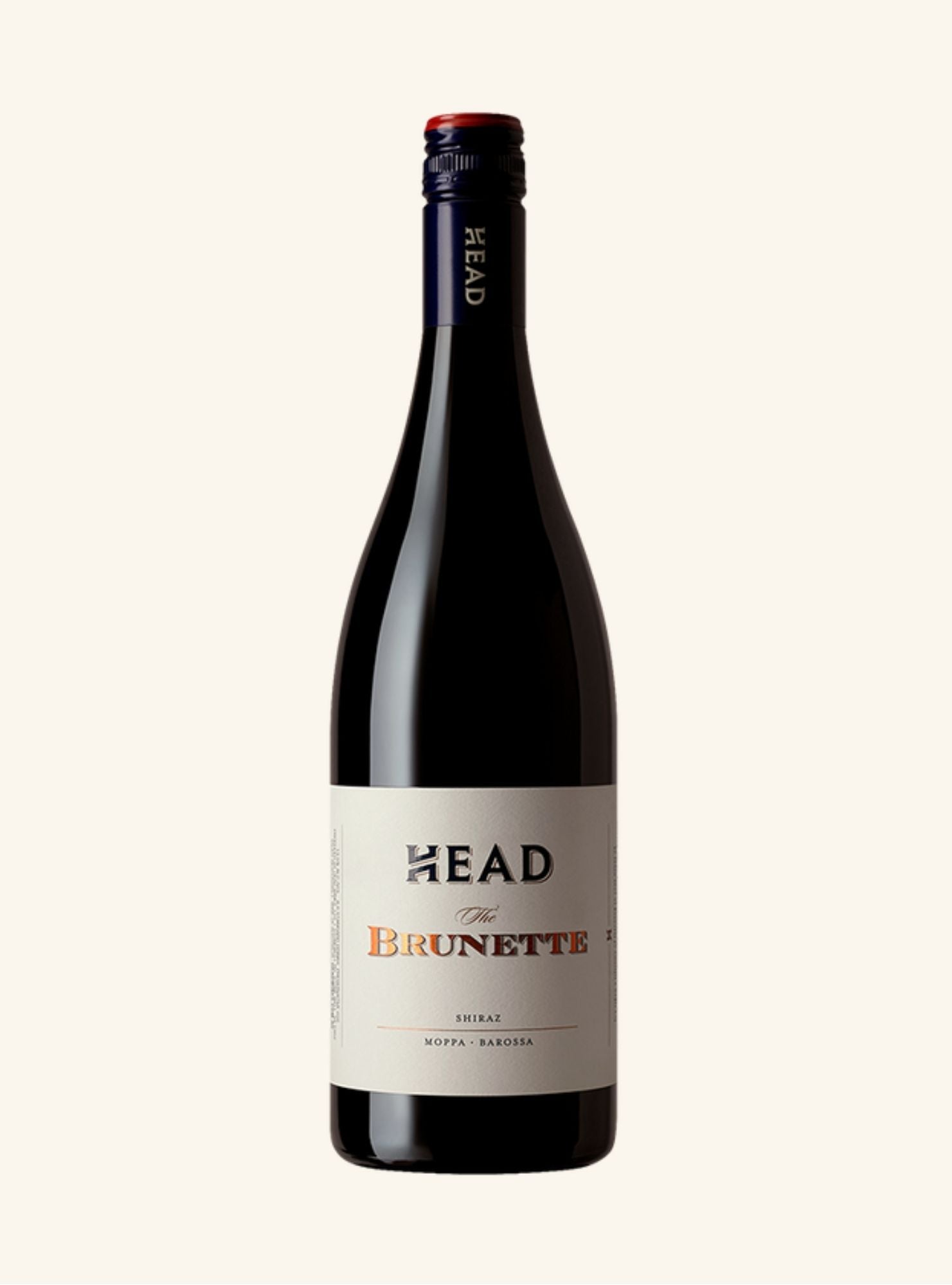 Wine bottle labeled 'The Brunette' by 'HEAD' on a white background
