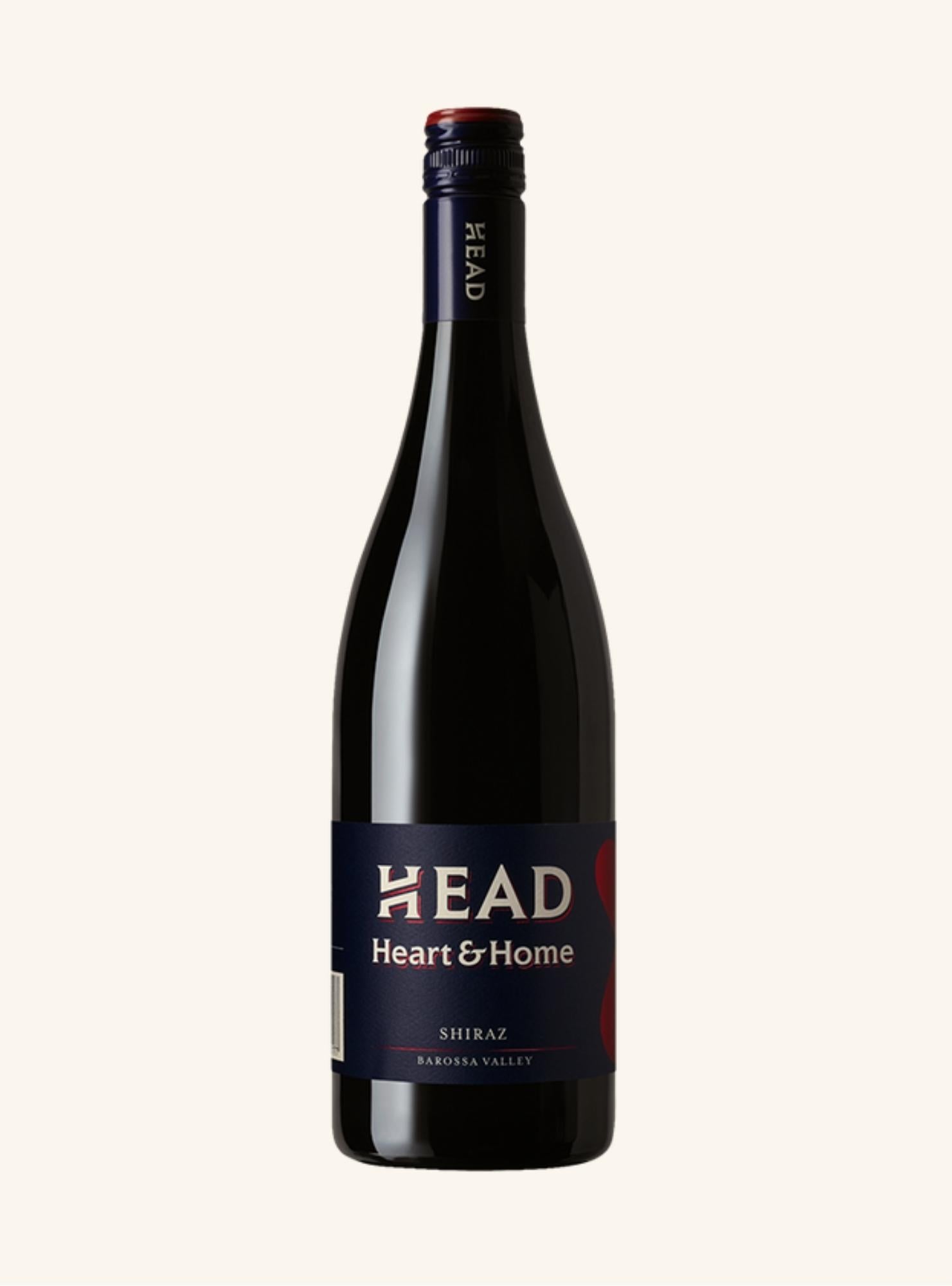 Red wine bottle with 'HEAD heart and home' label on a white background
