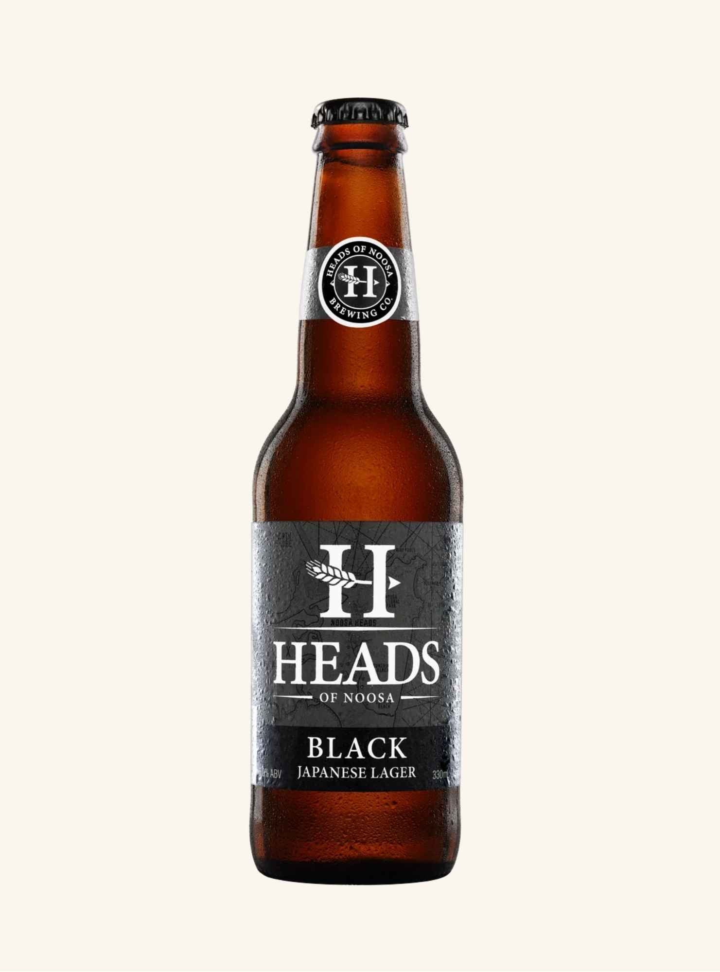Brown beer bottle with 'Heads of Noosa black japanese lager label on a white background