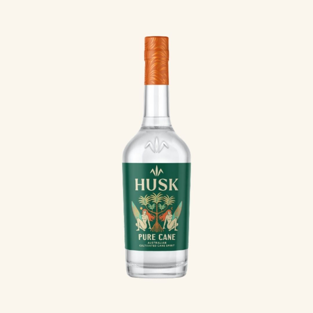 Bottle of Husk Pure Cane with a green label and orange cap, on a white background