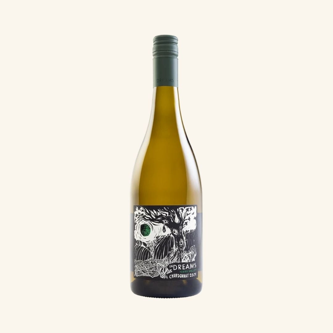 bottle of wine branded in dreams chardonnay with a artistic label in black and white on a white background.