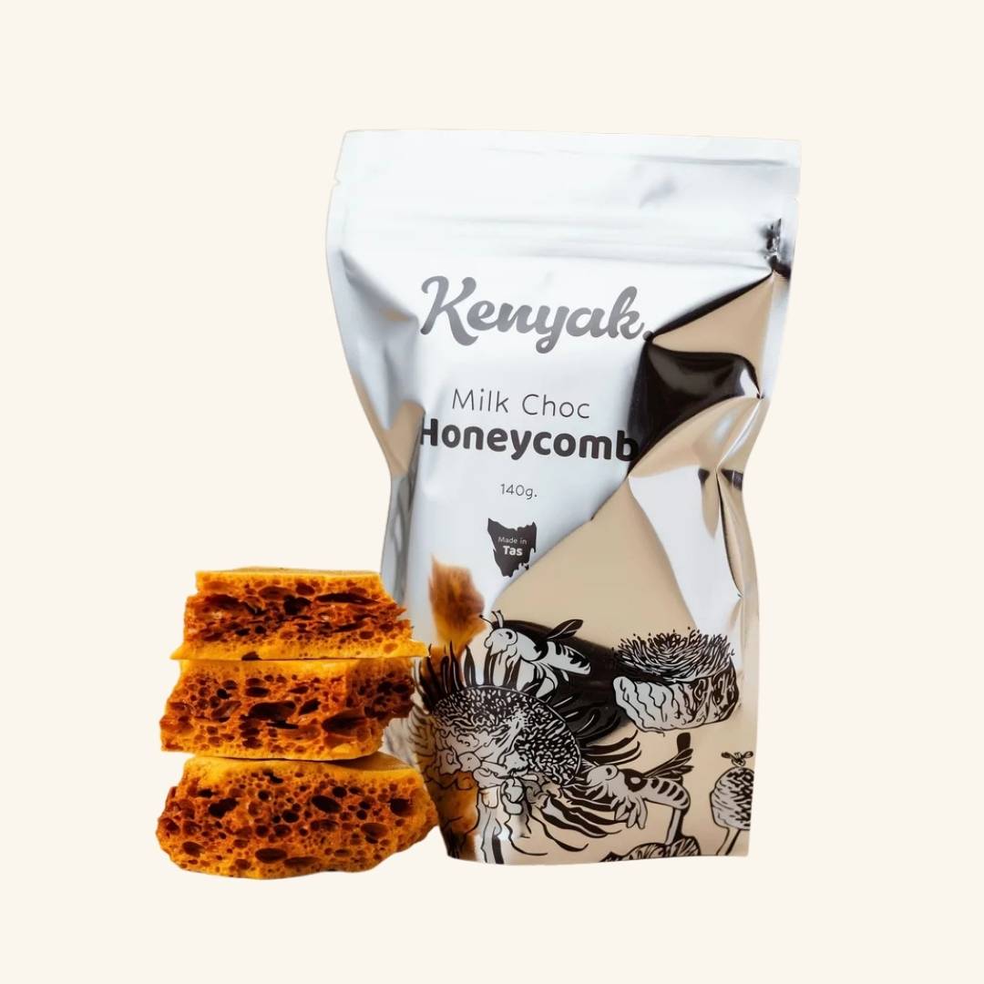 Kenyak Milk Choc Honeycomb packaging with honeycomb pieces on a white background