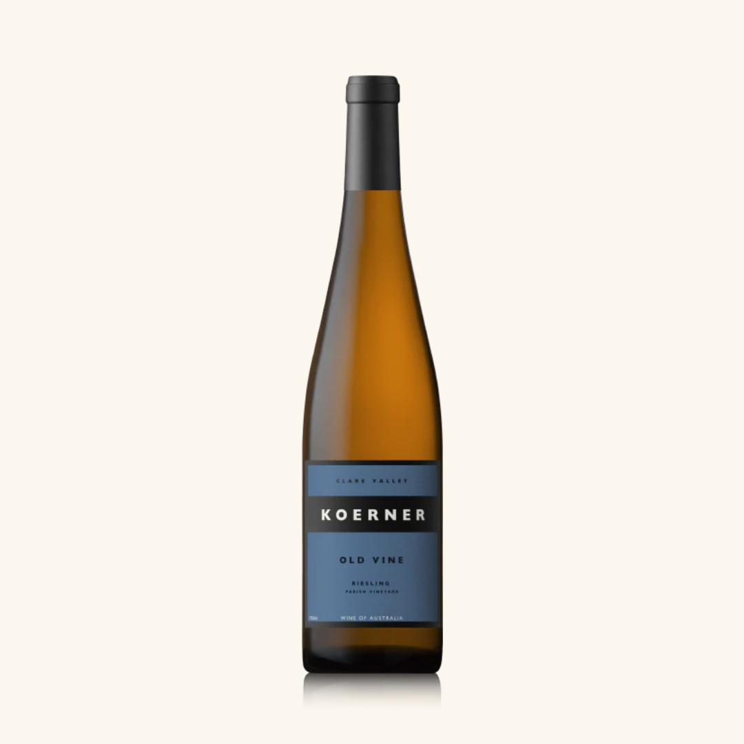 A bottle of Koerner Old Vine Riesling wine with a label indicating the brand and variety, set against a plain background.