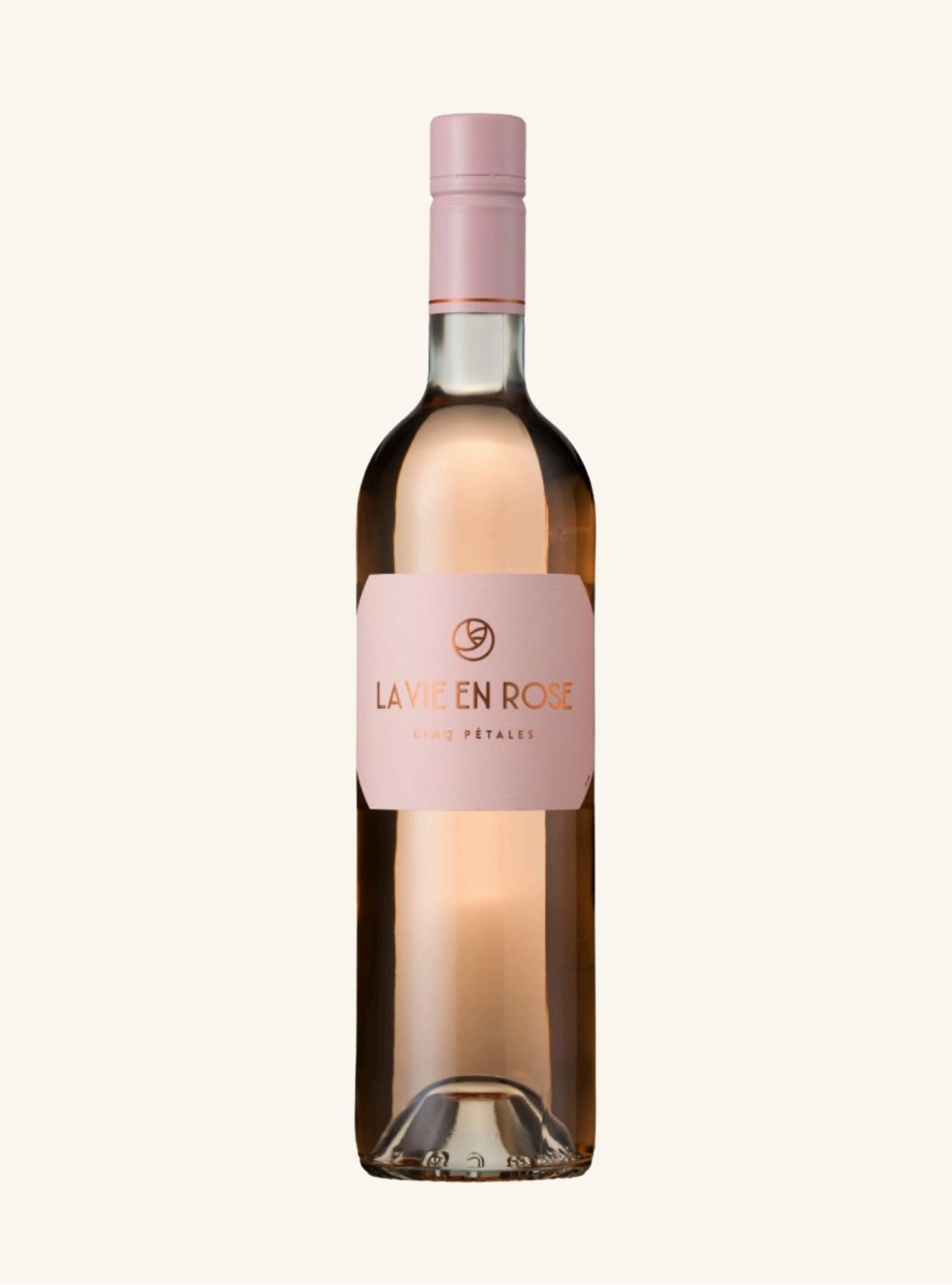 A bottle of La vie en Rose Rosé rosé wine with a pale pink label and matching pink capsule, set against a solid off-white background.