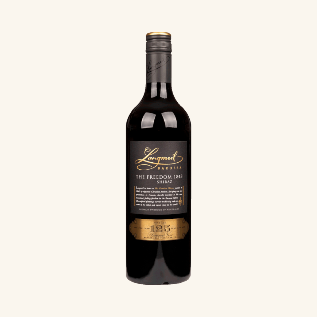 A bottle of Langmeil The Freedom 1843 Shiraz wine with a dark label and text, against a plain background.