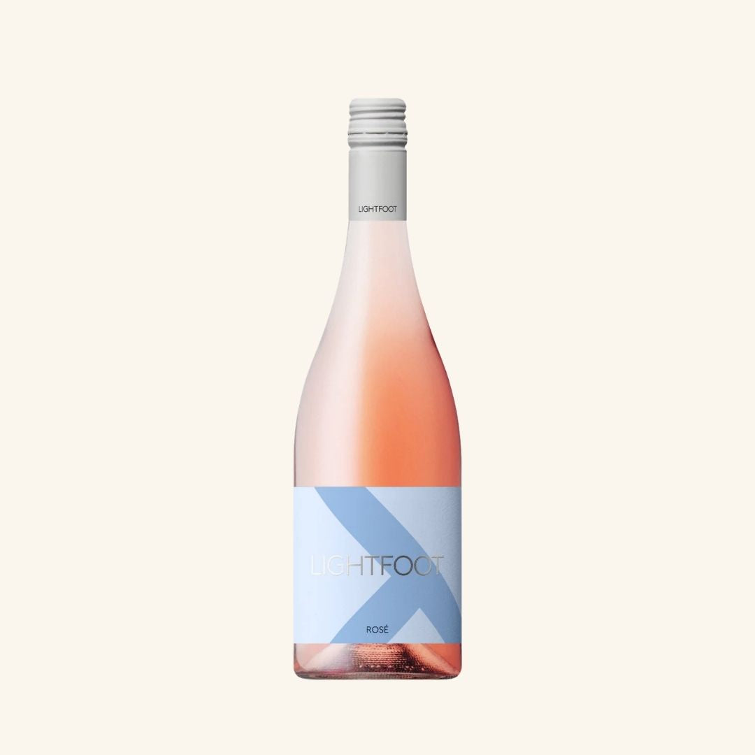 Wine bottle with a light pink color and blue label branded lightfoot rose on a white background