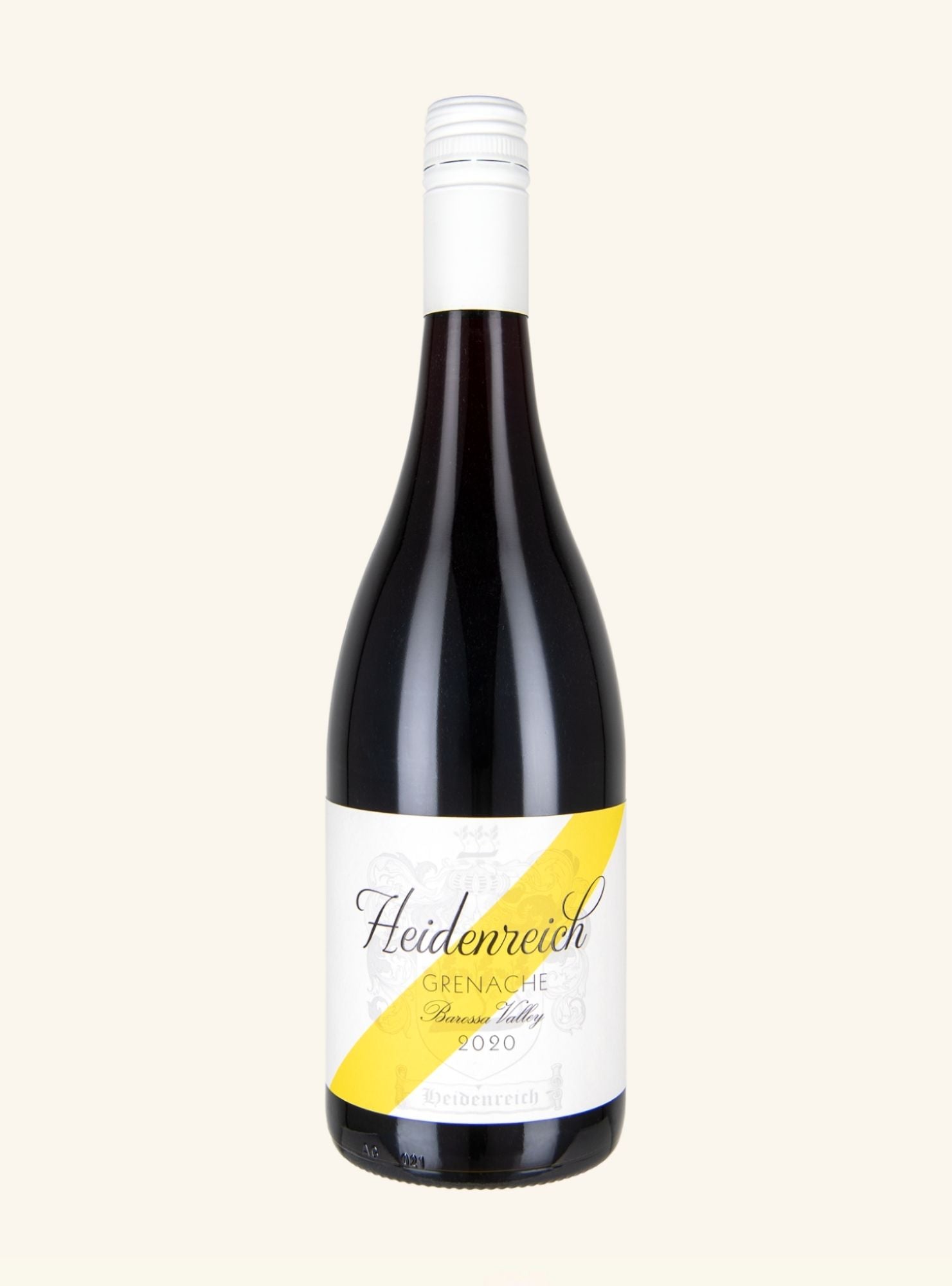 A bottle of Heidenreich Grenache from the Brenner Valley 2020, featuring a dark glass body, a white screw cap, and a white label with a bold yellow diagonal stripe, set against a solid off-white background.