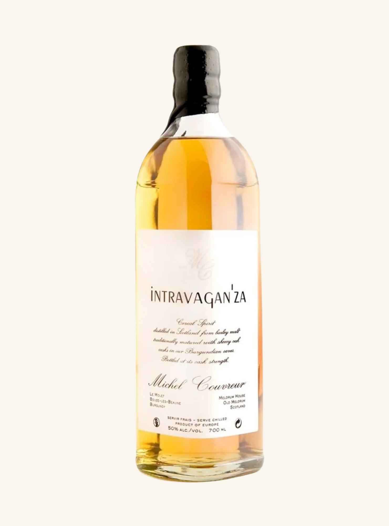 A bottle of Intravagn'za Michel Couvreur whiskey drink, showing a golden amber liquid inside a clear glass bottle with a white label and black cap, set against a solid off-white background.