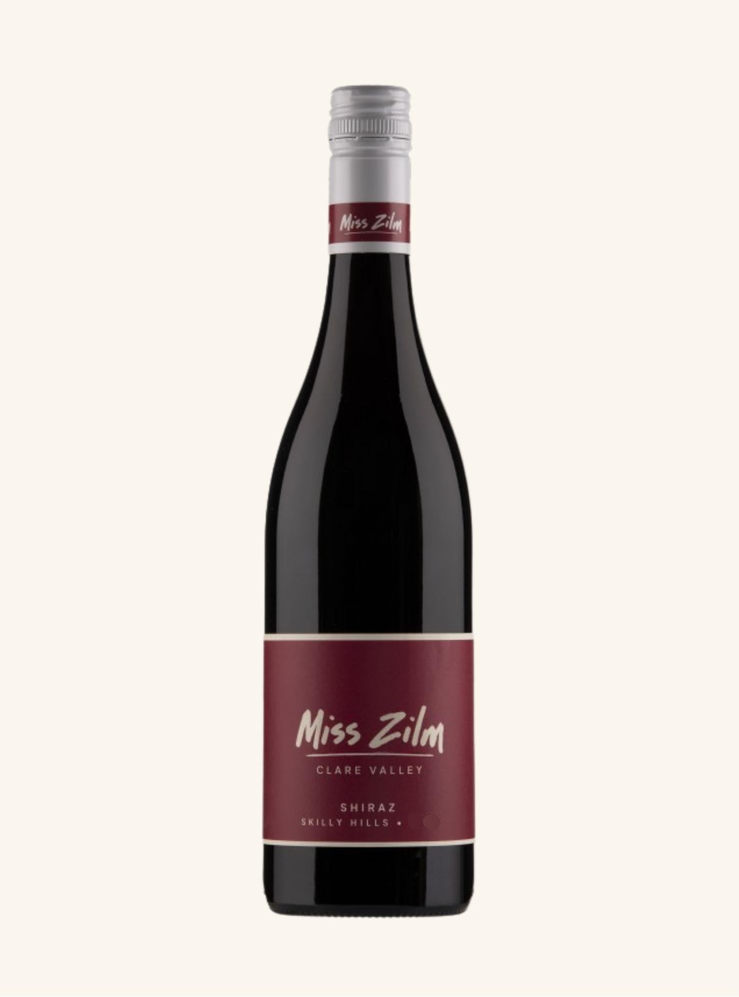 A bottle of Miss Zilm Clare Valley Shiraz wine against a solid off-white background. The bottle is dark glass with a prominent burgundy label and a silver screw cap.
