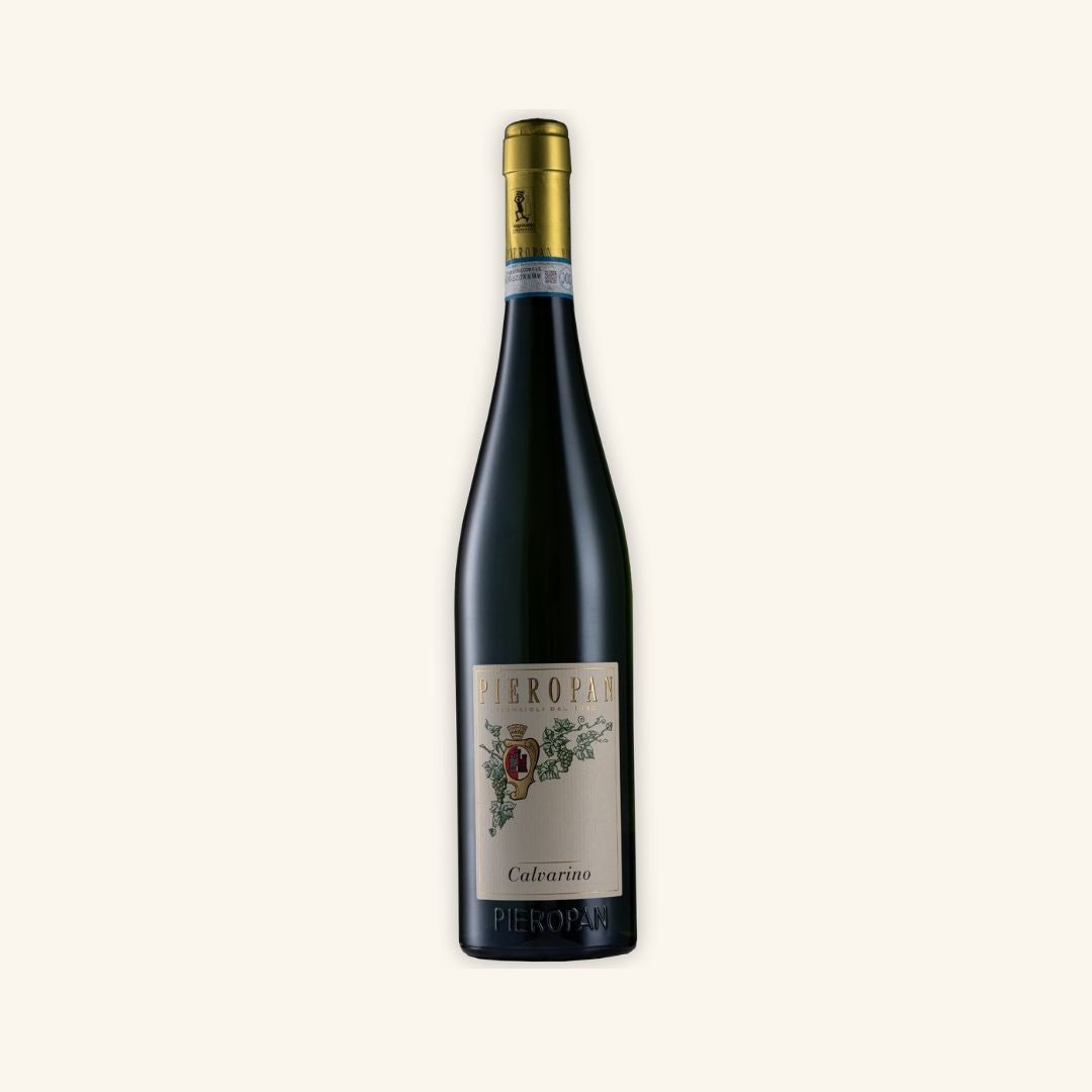 tall wine bottle branded pieropan calvarino with a gold cap and on a white background.