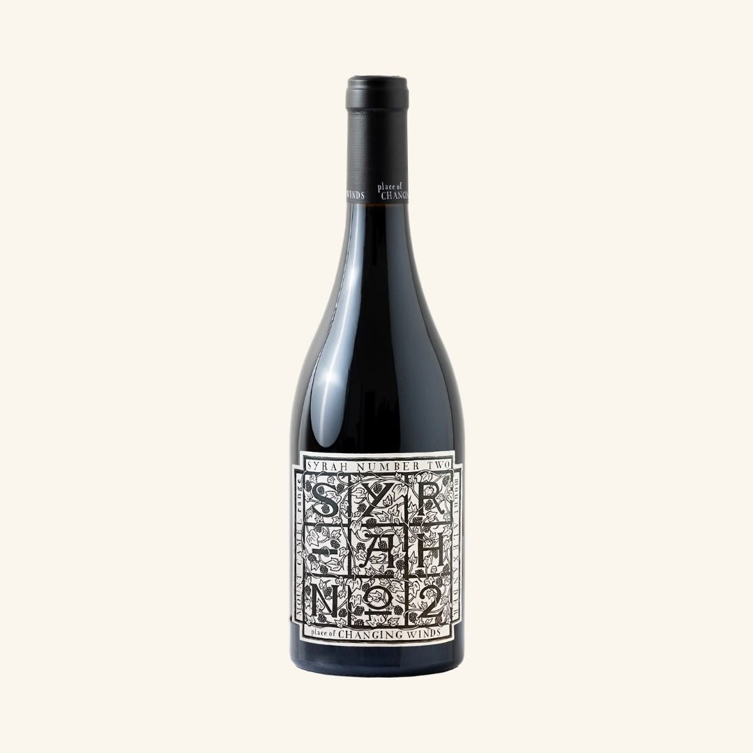 Wine bottle with a decorative label on a white background, branded syrah number two by place of changing winds.