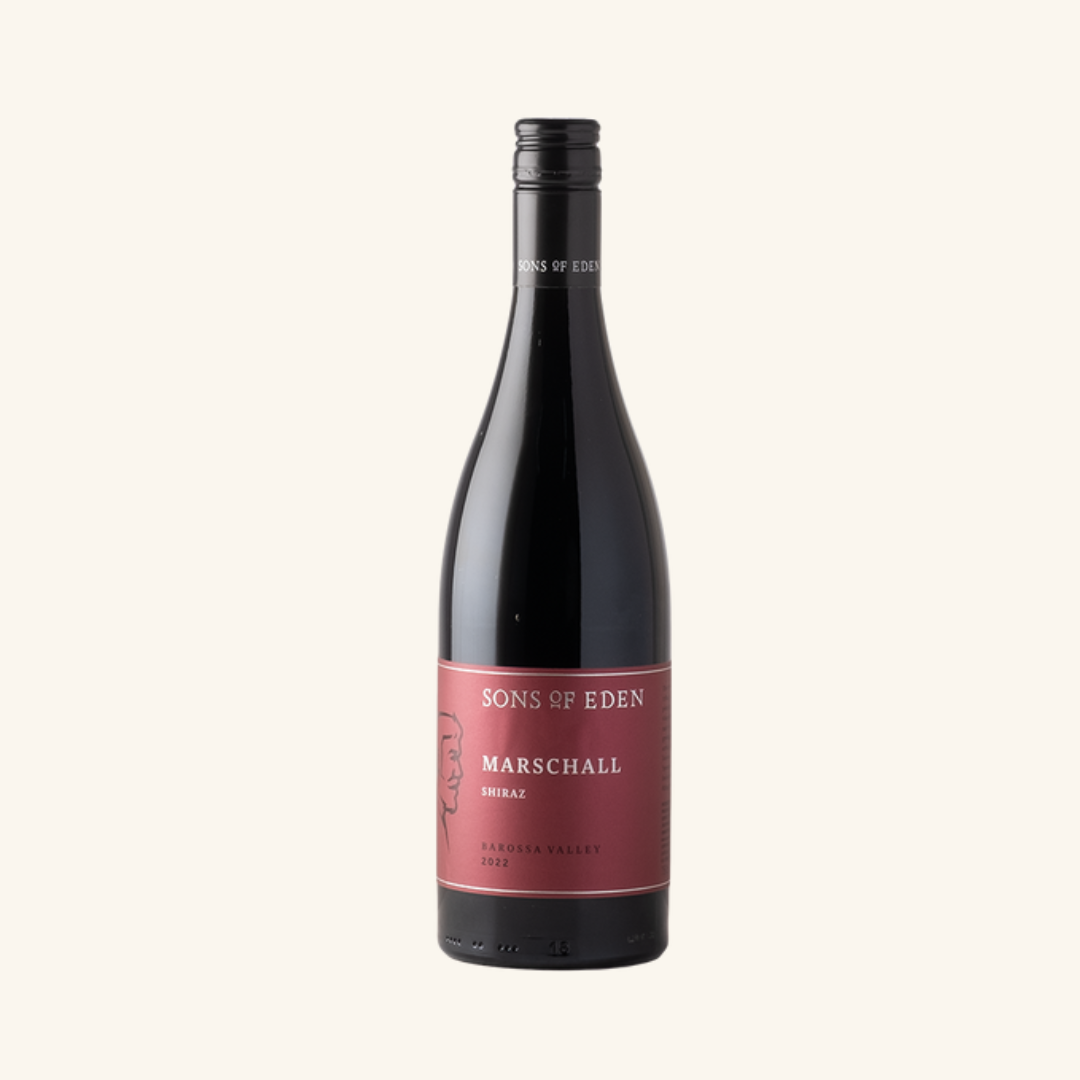 A bottle of Sons of Eden Marschall Shiraz wine with a red label, text, and a man visible.