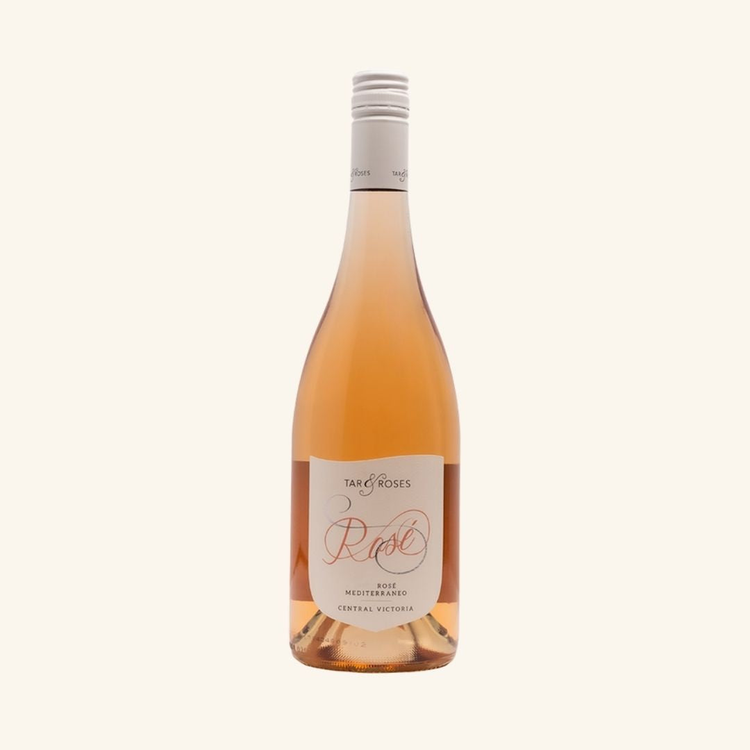 Bottle of rose wine with a white label braned tar & Roses rose on a light beige background