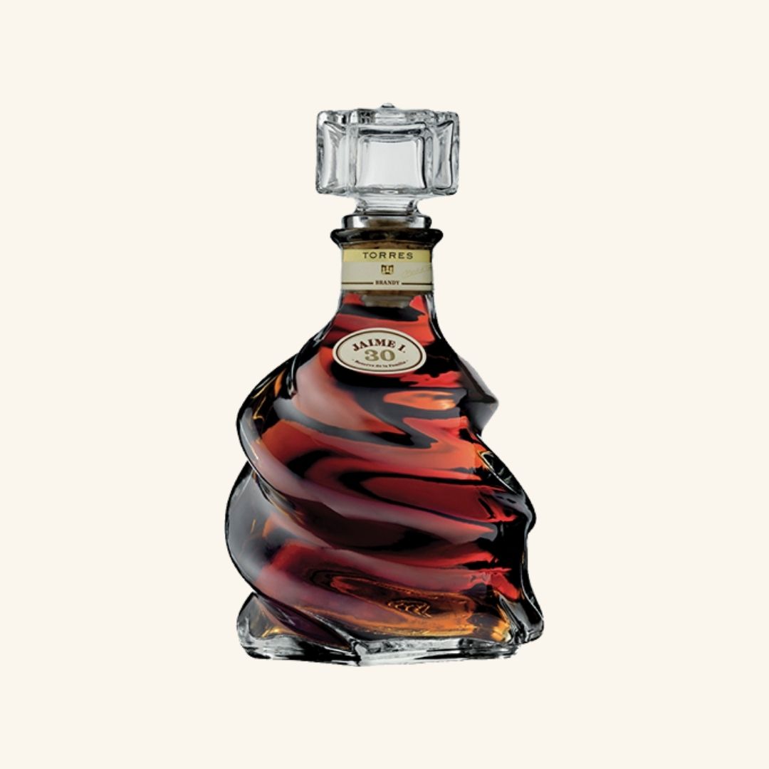 Decorative bottle with swirling design branded torrres jaime 1 on a white background