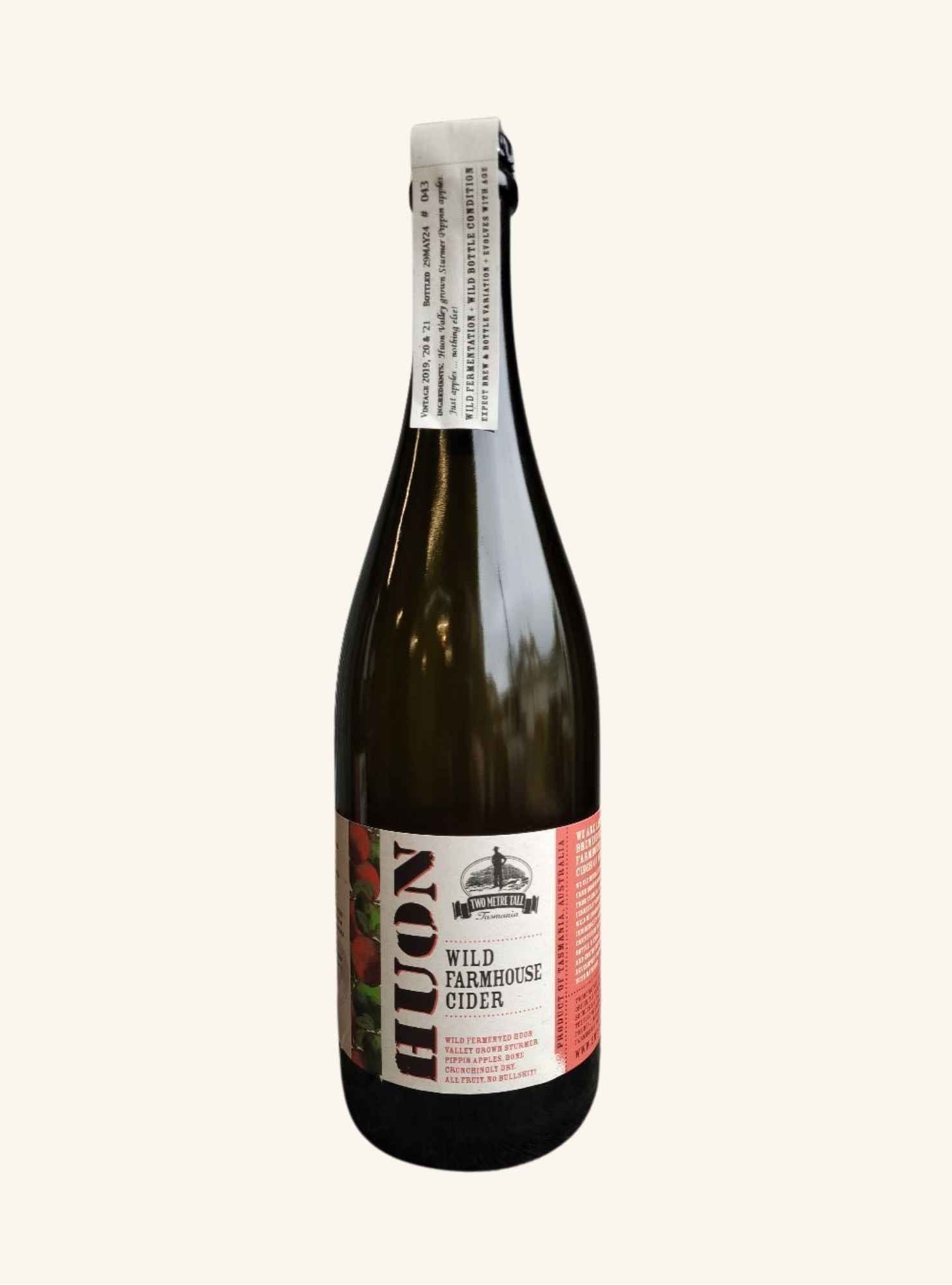 Bottle of Huon Wild Farmhouse Cider on a white background